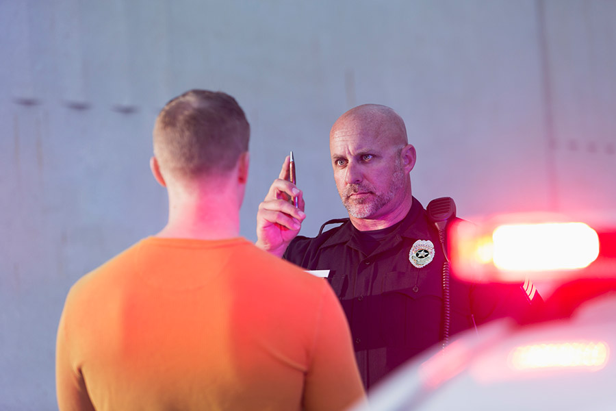 policeman staring at man in custody